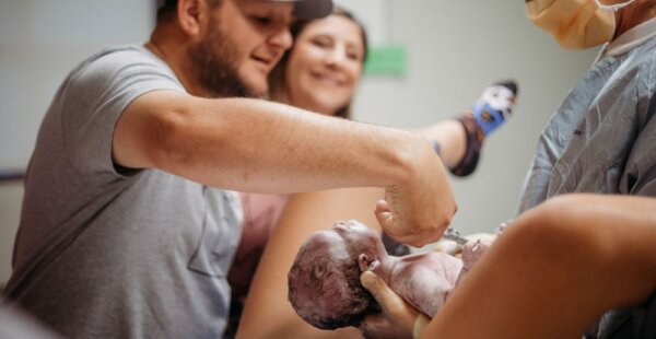 Drew East cutting the cord after the birth of his daughter via gestational carrier (Photo credit: Southern Chic Photography by Kelsea)